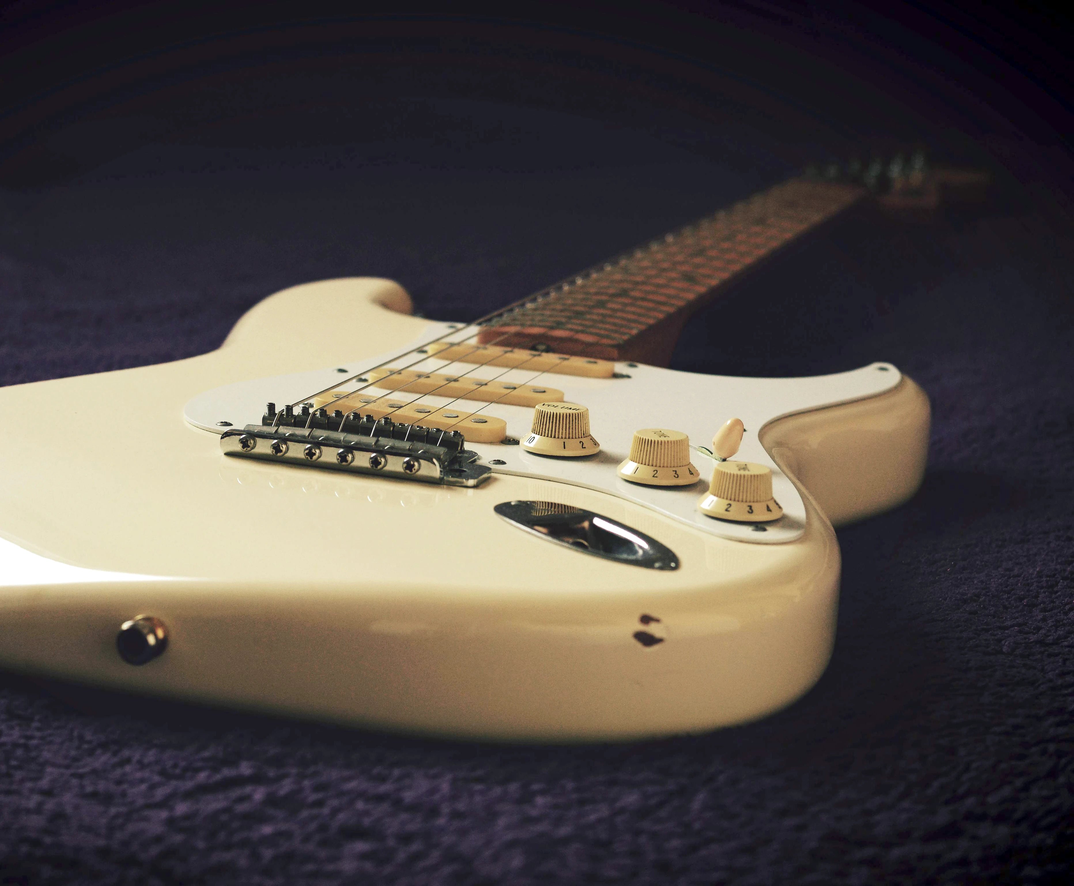 Ivory colored Stratocaster close up of knobs.