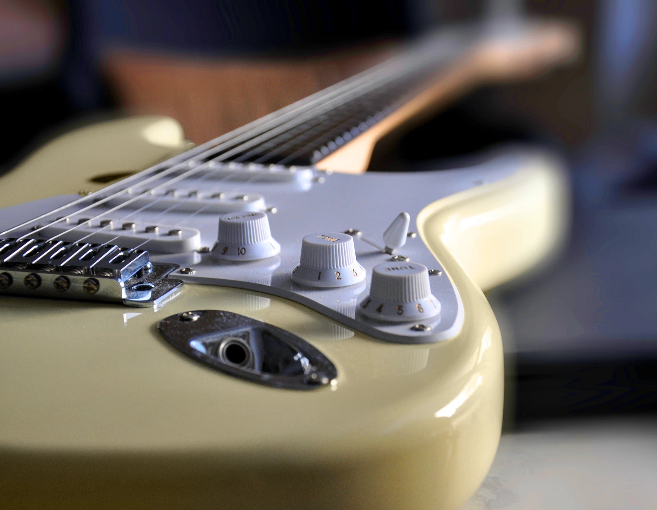 Ivory colored Stratocaster close up of knobs.