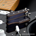 The BzzzzKill Dual Layer device for eliminating Fender Stratocaster 60 cycle hum in all pickup selector positions. Sitting on black Stratocaster. With text "Installs under pickguard".