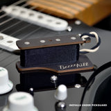 The BzzzzKill Single Layer device for eliminating Fender Stratocaster 60 cycle hum in all pickup selector positions. Sitting on black Stratocaster. With text "Installs under pickguard".