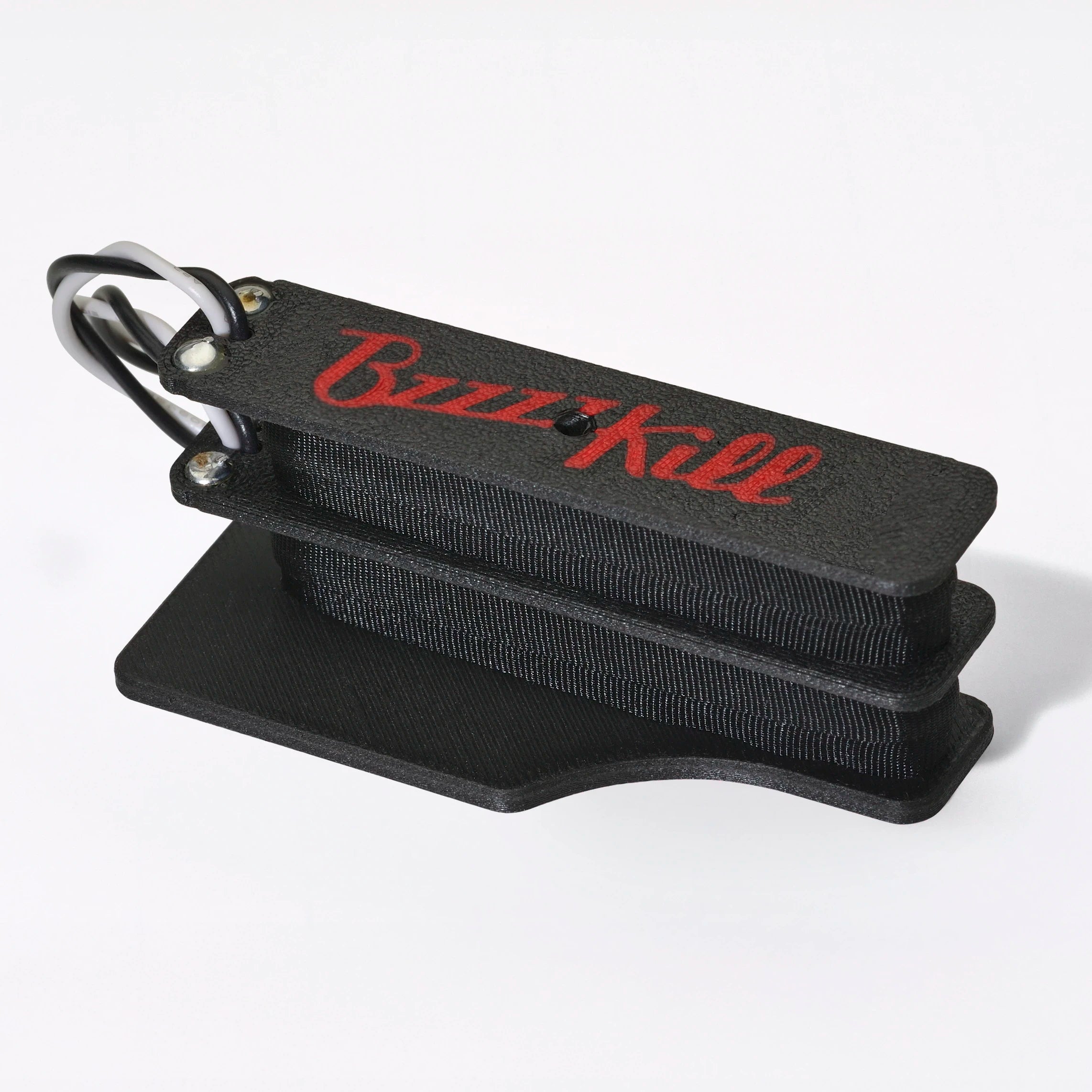 The BzzzzKill Dual Layer Players Series device for eliminating Fender Stratocaster 60 cycle hum in all pickup selector positions. On white background. For left handed guitars.