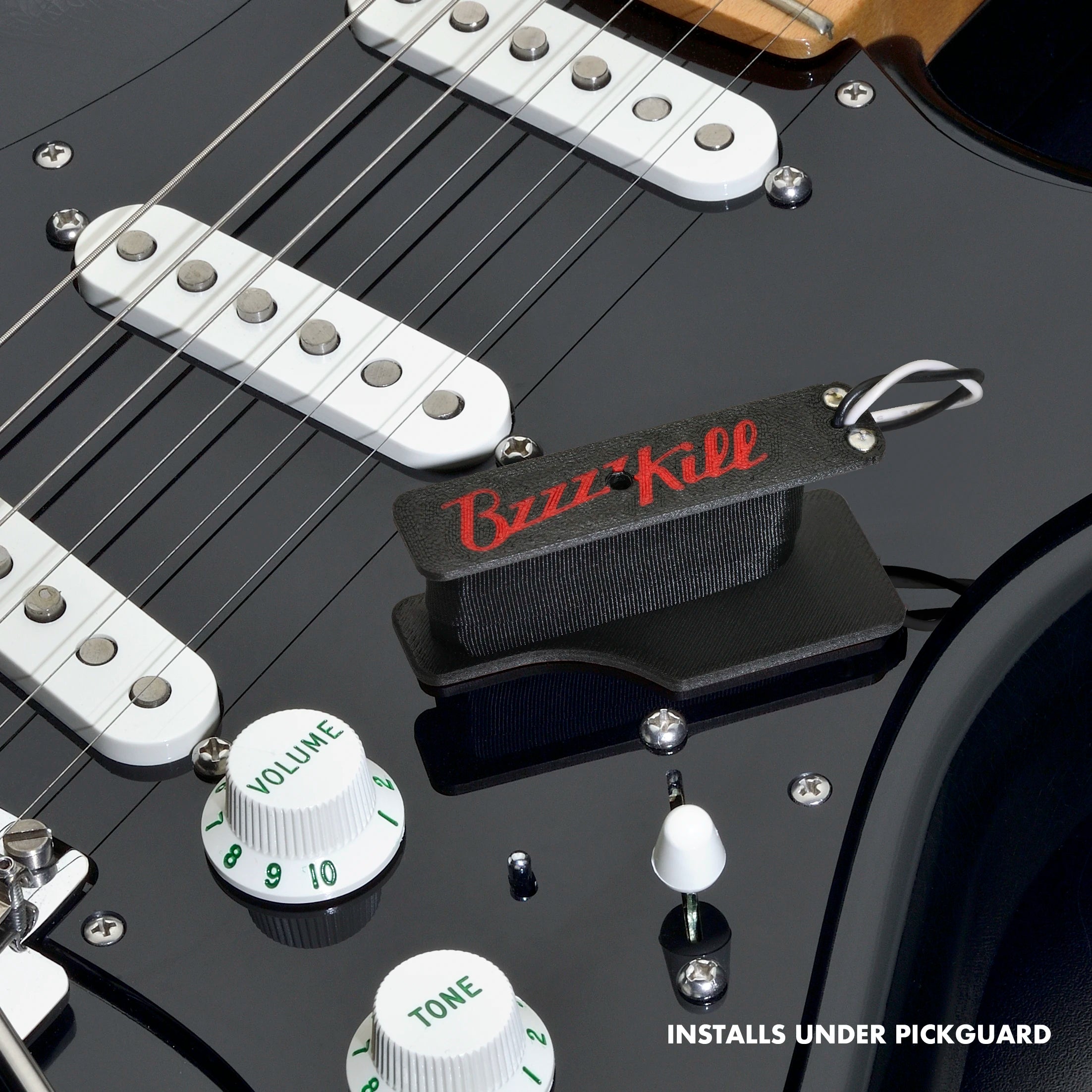 The BzzzzKill Single Layer Players Series device, sitting on a black Stratocaster with text reading: Installs under pickguard.